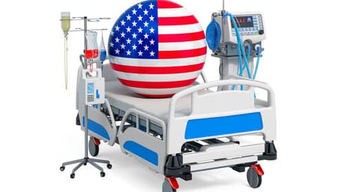 le drapeau américain avec un lit d'hôpital et un pied à perfusion, pour représenter l'assurance maladie aux USA.