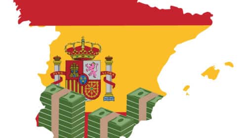 Le territoire espagnol, au couleur du drapeau espagnol, accompagné de billets, pour représenter le thème des charges patronales en Espagne.