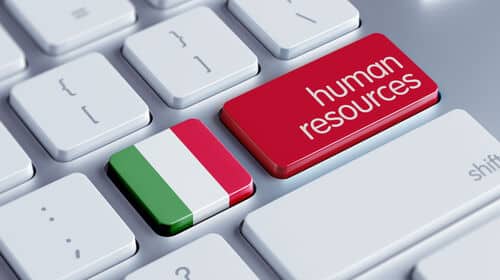 Un clavier avec un bouton aux couleur du drapeau italien et un bouton avec les termes "human services" pour représenter le thème de "recruter en Italie".